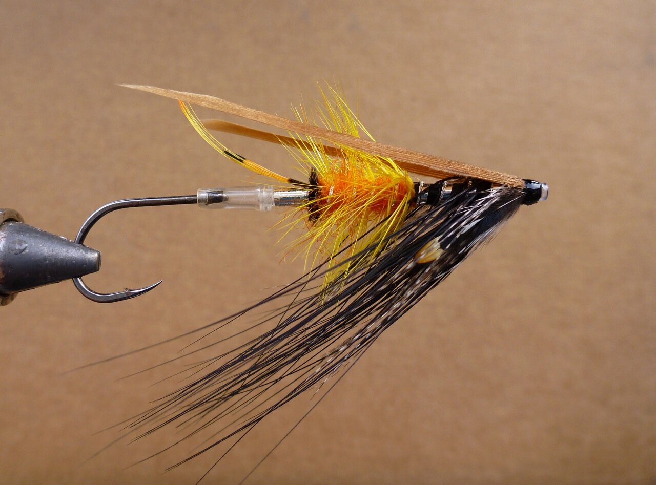 The Akroyd Dee It was originally tyed back in the late 1800's, Kelson (1895) and later Pryce-Tannatt (1914) both listed this fly in their books on Dressing Salmon Flies. Dee style flies were named after the river Dee in Scotland, as were Spey (river Spey) and Don flies (river Don) etc. These styles were later fished on many different rivers world wide for Atlantic Salmon & Steelhead (Haig-Brown). The Akroyd pictured here was tyed yesterday and will be fished. I've also took the liberty to tye it in different colours & vary it a bit. The Dee style wing stabilizes the hook so it swims true (hook down). Spin one up and give it a go !! The Akroyd (pictured) tag: silver tinsel tail: a topping and tippet in strands butt: black herl body; rear half light orange seal's (sub) fur, front half black floss hackle: yellow hackle over the orange, heron (sub) over the black floss rib: oval silver over the orange seal's fur, flat silver and twist over the floss throat: teal wing: cinnamon turkey cheek: jungle cock Material Source: www.canadiantubeflies.com First Cast Fly Shop; 519-766-4665 Guelph Book Source: Spey Flies & Dee Flies; John Shewey Spey Flies, how to tie them; Bob Veverka Salmon Patterns; Mike Radencich