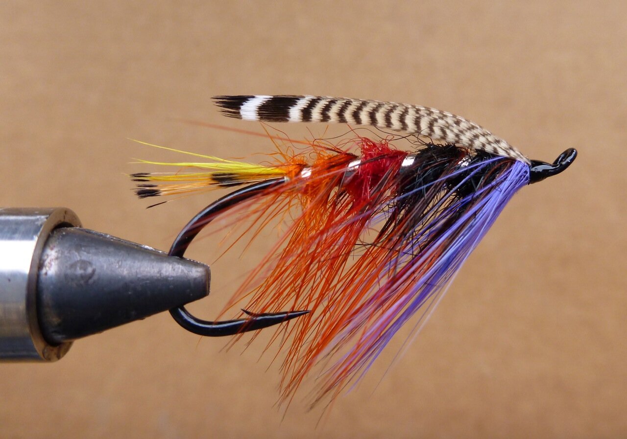 The Drake: This pattern is in Michael Radencich's book, Salmon Fly Patterns, pg. 70. Originally from; Francis Francis; A Book on Angling, fourth edition,1876 The Drake Tail; tippet sprigs and yellow toucan (I used marabou for toucan) Body; orange,red, & black pig's wool (seal's fur or sub) Rib; broad silver tinsel (flat tinsel) Hackle; coch-y-bondhu dyed dark orange Throat; lavender hackle Wing; two strip of pintail or summer duck (wood duck)