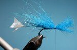 Tie in a small amount of blue fox hair on the top of the hook, make sure it is not longer back than the tails. And again don’t cut the waste!