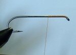 Start thread at eye and wrap back approximately 1/3 the length of the hook shank. Next wrap back to the front leaving about the width of the dumbbell eye away from the hook eye.