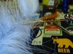 Select a marabou feather that has a thin center stem and good flowing fibers. Peel the fibers backwards and tie the marabou in near the tip with 1-2 wraps, then pull that piece backwards and add 1 more wrap.