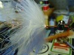 Advance your thread forward to the half-way point of the hook shank.Palmer the marabou forward being careful to not bind any fibers underneath each wrap. Stop and tie it off before you get to the thick brittle stem of the feather, using 5 wraps over the marabou then three behind before trimming the excess stem and feather. Straighten and make sure the fibers wrapped neatly then blow or use your left hand to pull the fibers back evenly. Brian Wise has a few awesome videos on you tube showing this technique. https://www.youtube.com/watch?v=SlSvnycHDZE&feature=c4-overview-vl&list=PL550F52FC398332B2