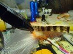 Flip hook up and pierce thru center of strip slide it back and down the bend. You will have to remove it from the vise after piercing to get it the rest of the way down.