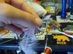 Select a Schlappen feather pluck the rough fibers near the base of the stem, next tie the feather in near the tip by slightly peeling back adjacent fibers. Wrap forward making a nice taper then return the thread to the tie in point.