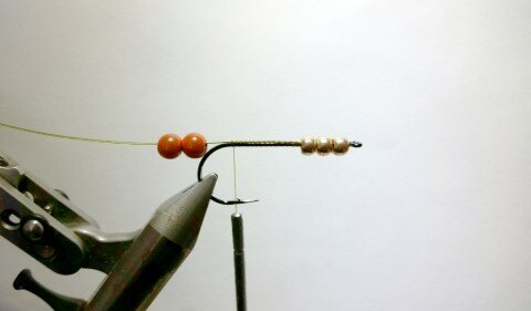 Push tungsten beads forward as you tie in the wire and mount two 6mm plastic beads.